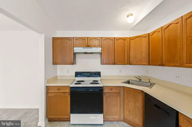 a kitchen with a stove and a sink