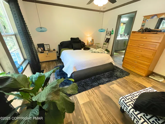 a bed sitting in a bedroom next to a window