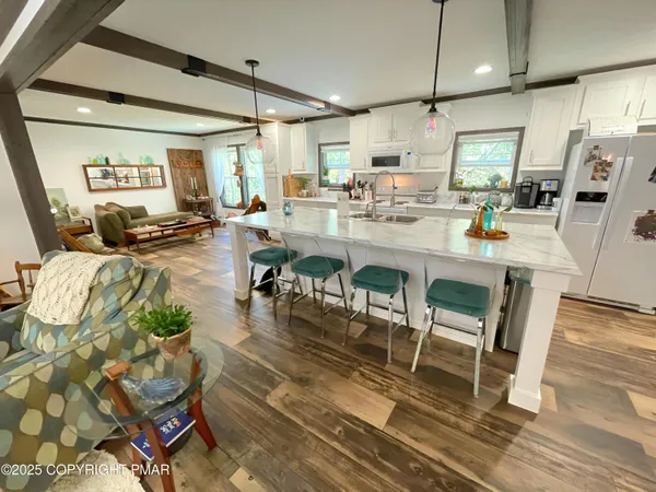 a kitchen with stainless steel appliances kitchen island granite countertop a stove a sink and a refrigerator