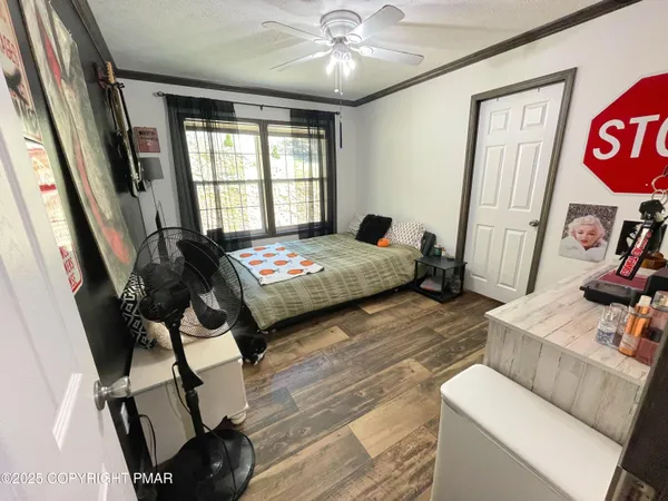 a bedroom with a bed and wooden floor