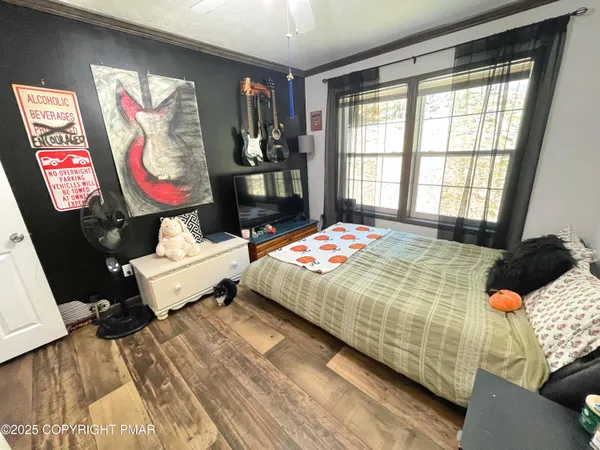a view of a hallway with wooden floor and windows