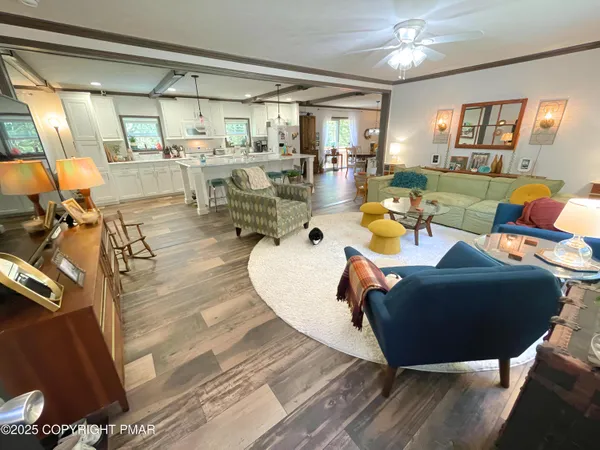 a living room with lots of furniture and a large window