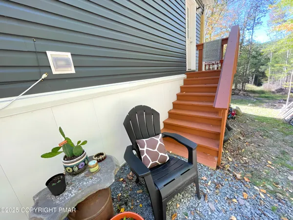 a view of a house with backyard and sitting area