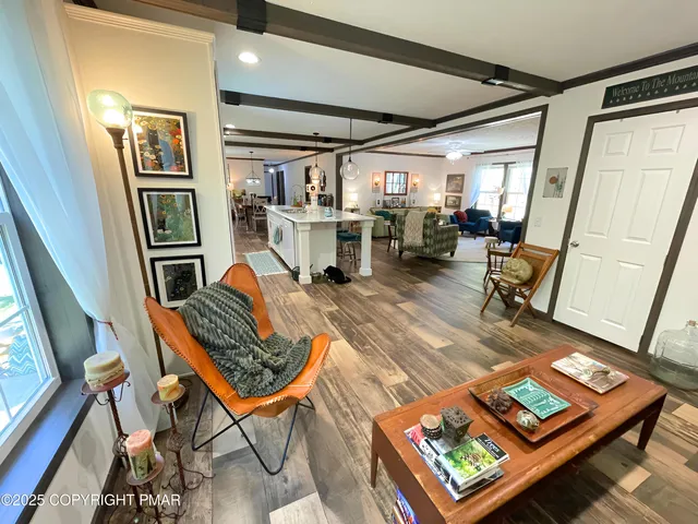 a living room with furniture rug and a window