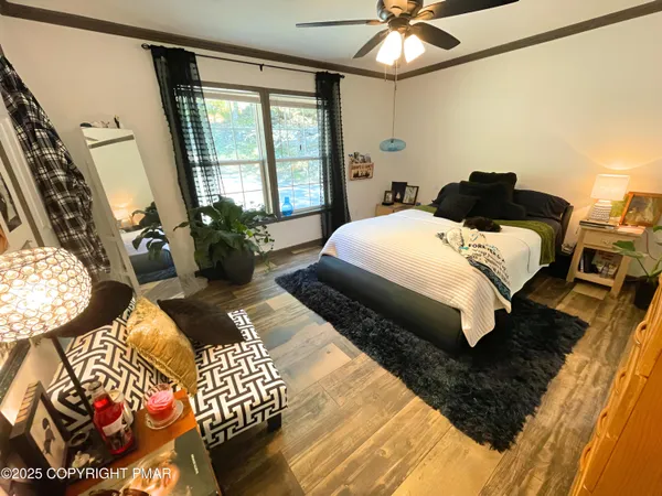 a bedroom with a bed mirror and window