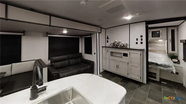 a kitchen with stainless steel appliances kitchen island granite countertop a sink and cabinets