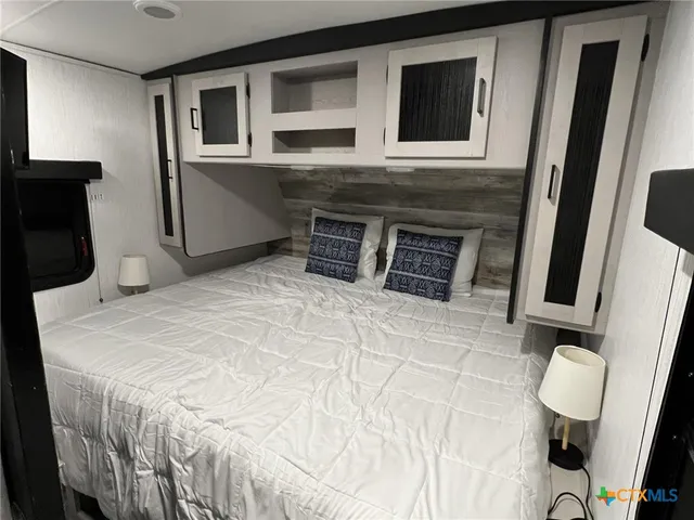 a bedroom with a bed and cabinets
