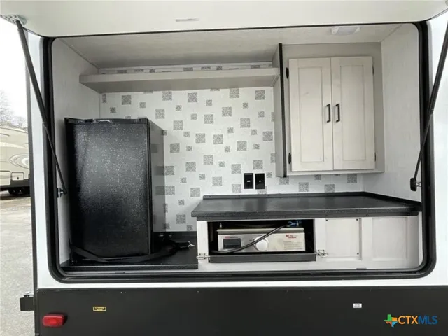 a bathroom with a mirror and a shower