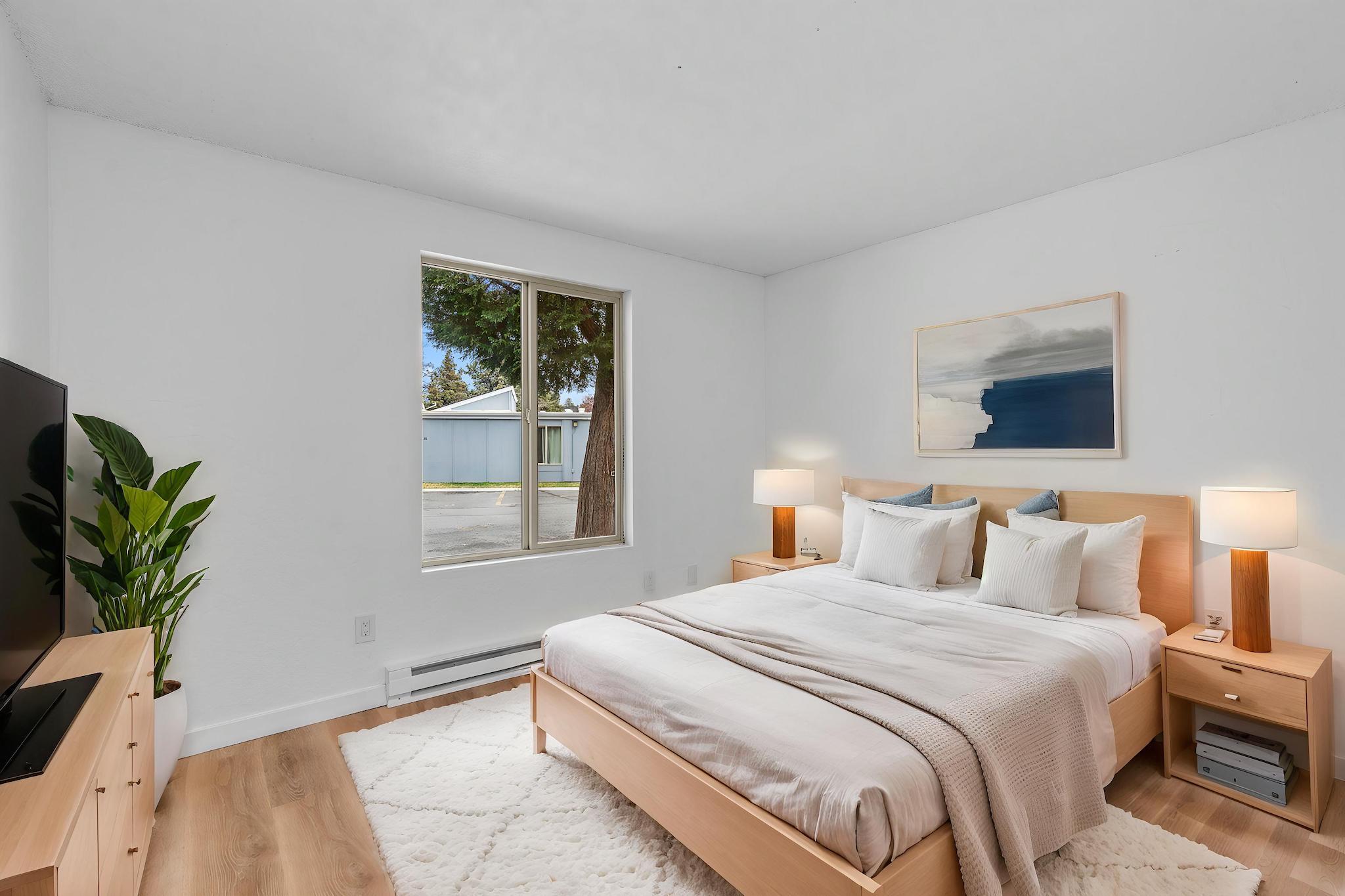 1700 Northeast Wells Acres Road, Unit 25 Bend, OR 97701 - Photo 16 of 25 a bedroom with a bed and a window