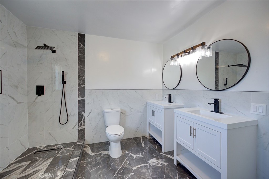 1550 Main Street Cambria, CA 93428 - Photo 2 of 9 a bathroom with a toilet a sink and mirror