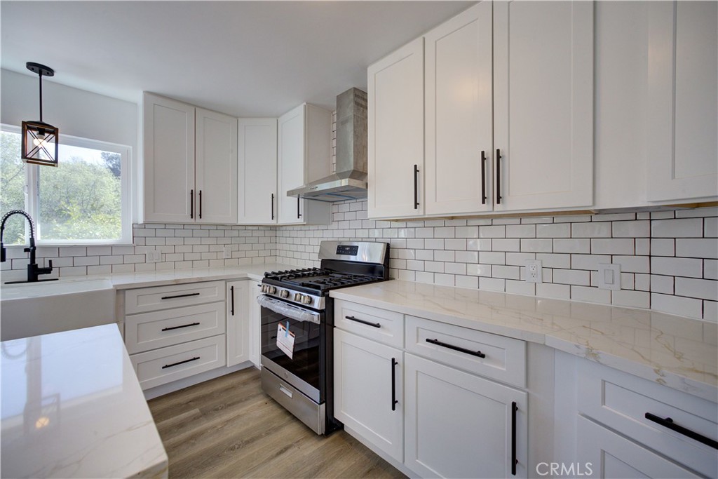 1550 Main Street Cambria, CA 93428 - Photo 4 of 9 a kitchen with granite countertop white cabinets and white appliances