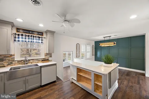 a kitchen with a sink and a stove top oven