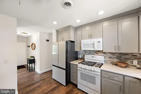 a kitchen with stainless steel appliances granite countertop a refrigerator sink and cabinets