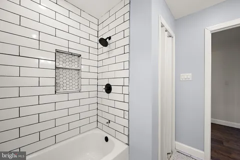 a bathroom with a bathtub and shower