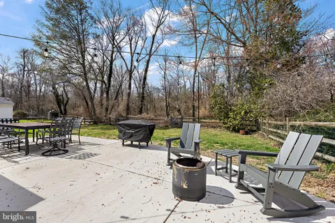 a view of a chairs and table in backyard of the house