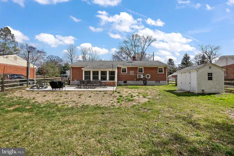 a backyard of a house with yard table and chairs