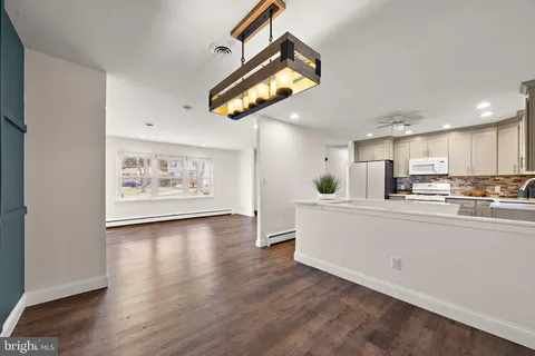a view of kitchen with cabinets and wooden floor