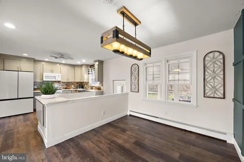 a kitchen with stainless steel appliances granite countertop a stove and wooden floor
