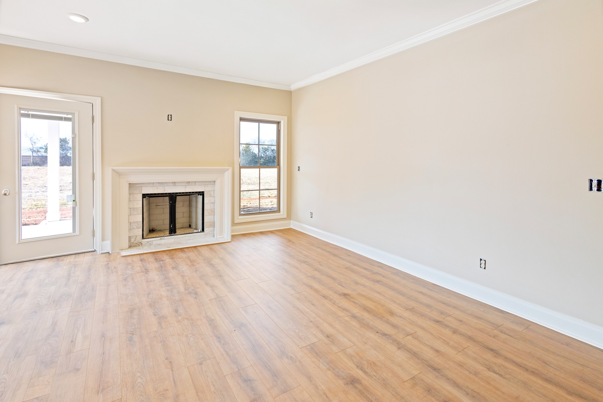 5552 Sinclair Street Murfreesboro, TN 37127 - Photo 7 of 18 an empty room with wooden floor fireplace and windows
