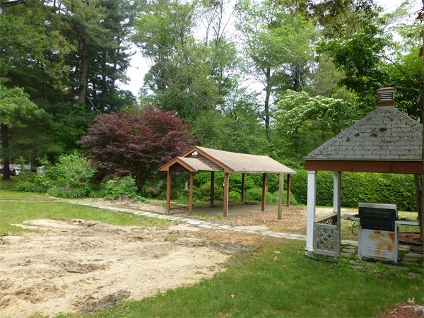 9 Sandberg Road Billerica, MA 01821 - Photo 23 of 23 a view of a patio with table and chairs under an umbrella