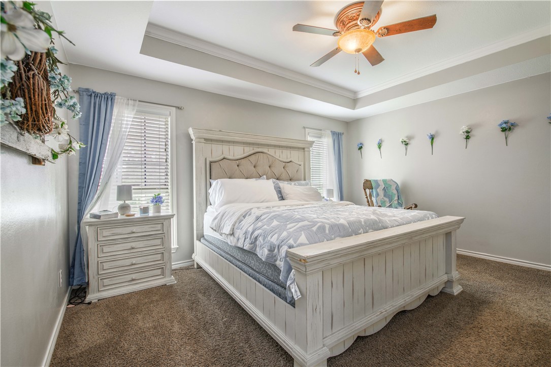 6538 Olympia Buddy Road College Station, TX 77845 - Photo 21 of 50 a bedroom with a bed and a chandelier