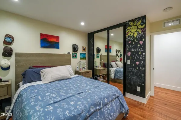 a bedroom with a large bed and a window