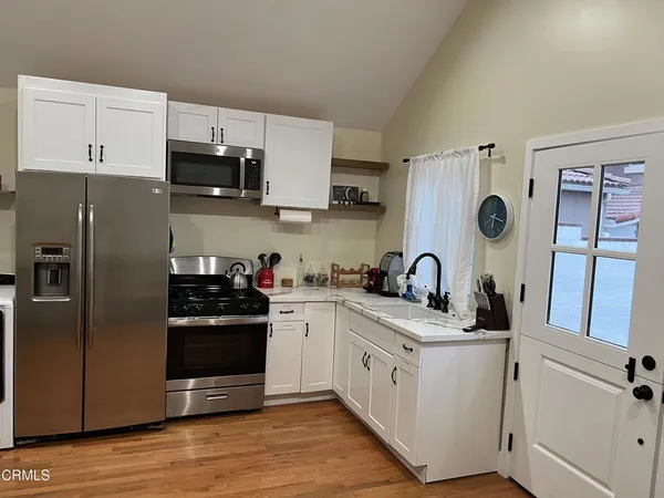 a kitchen with stainless steel appliances white cabinets and a sink