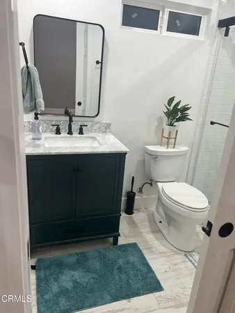 a bathroom with a sink mirror vanity and toilet