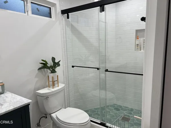 a white toilet sitting next to a bathroom sink