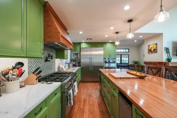 a kitchen with stainless steel appliances granite countertop a sink a counter space and cabinets
