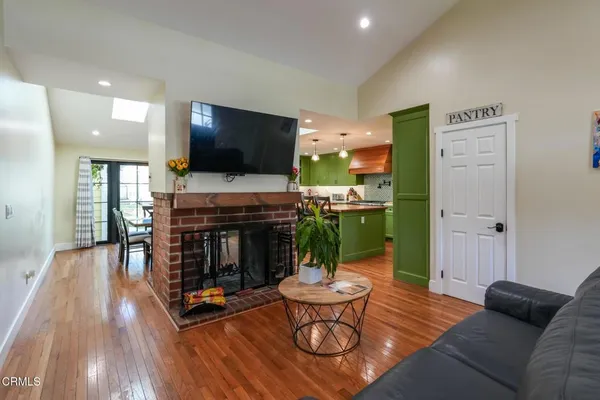 a living room with furniture a fireplace and a flat screen tv