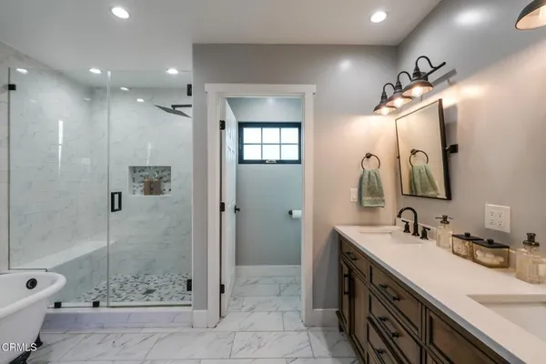 a bathroom with a double vanity sink mirror double and shower