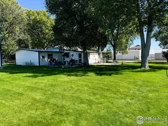 a house view with a sitting space and garden