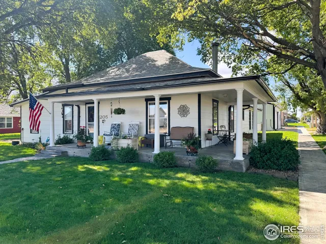 a front view of a house with a yard and porch