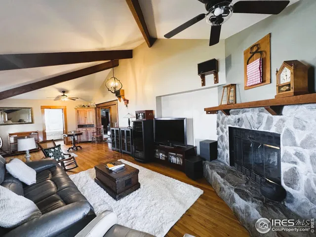 a living room with furniture a rug and kitchen view