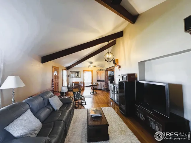 a living room with lots of furniture and wooden floors