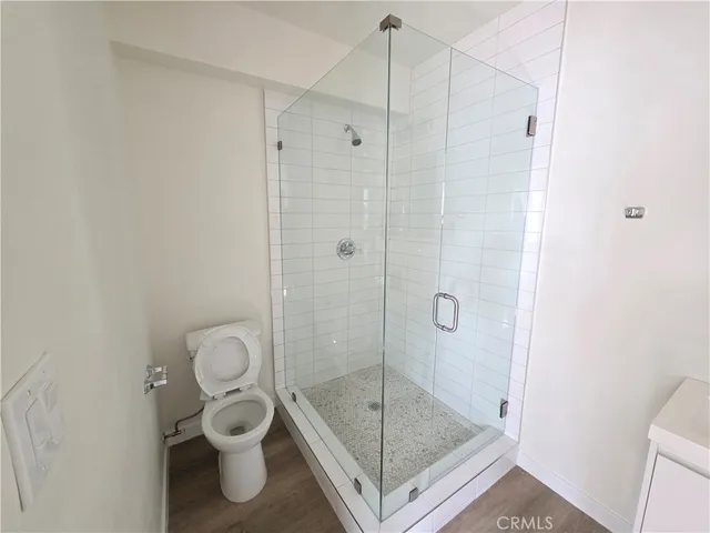 a bathroom with a shower a toilet and a sink