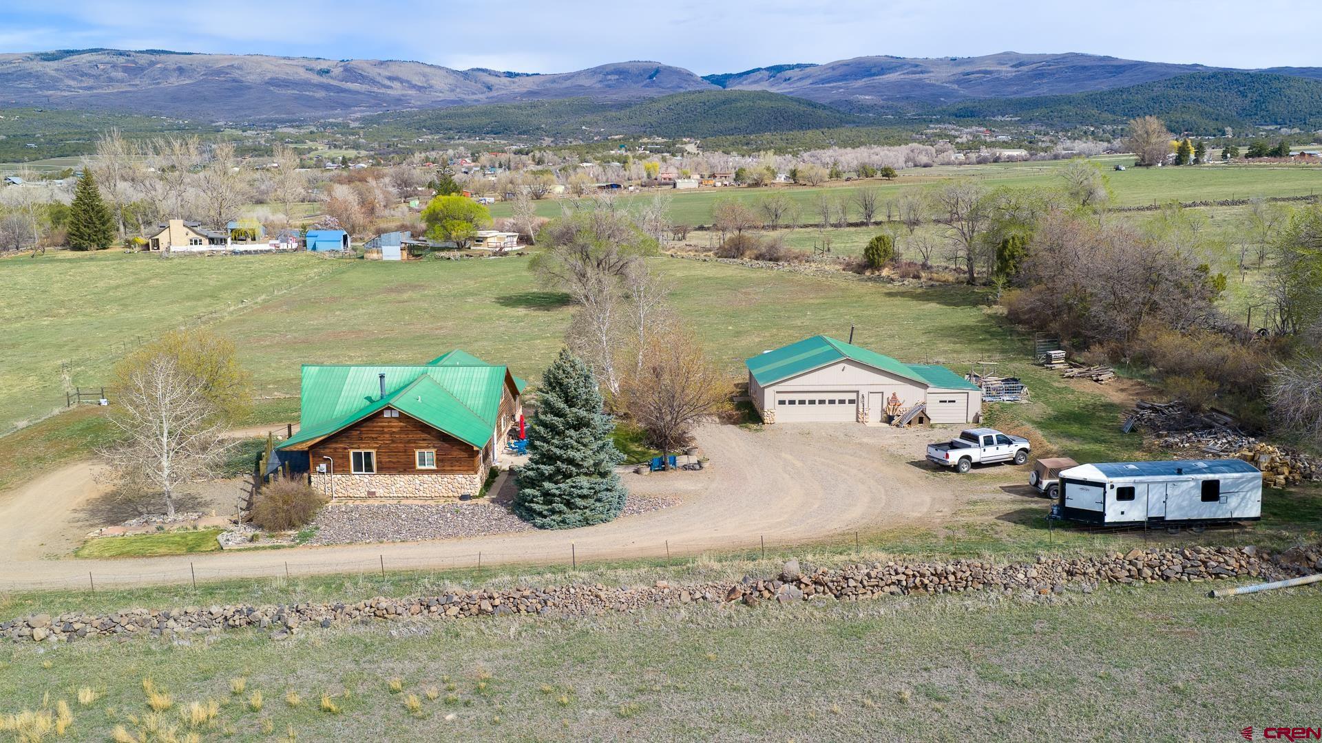 19122 2325th Road Cedaredge, CO 81413 - Photo 1 of 45 a view of lake with mountain