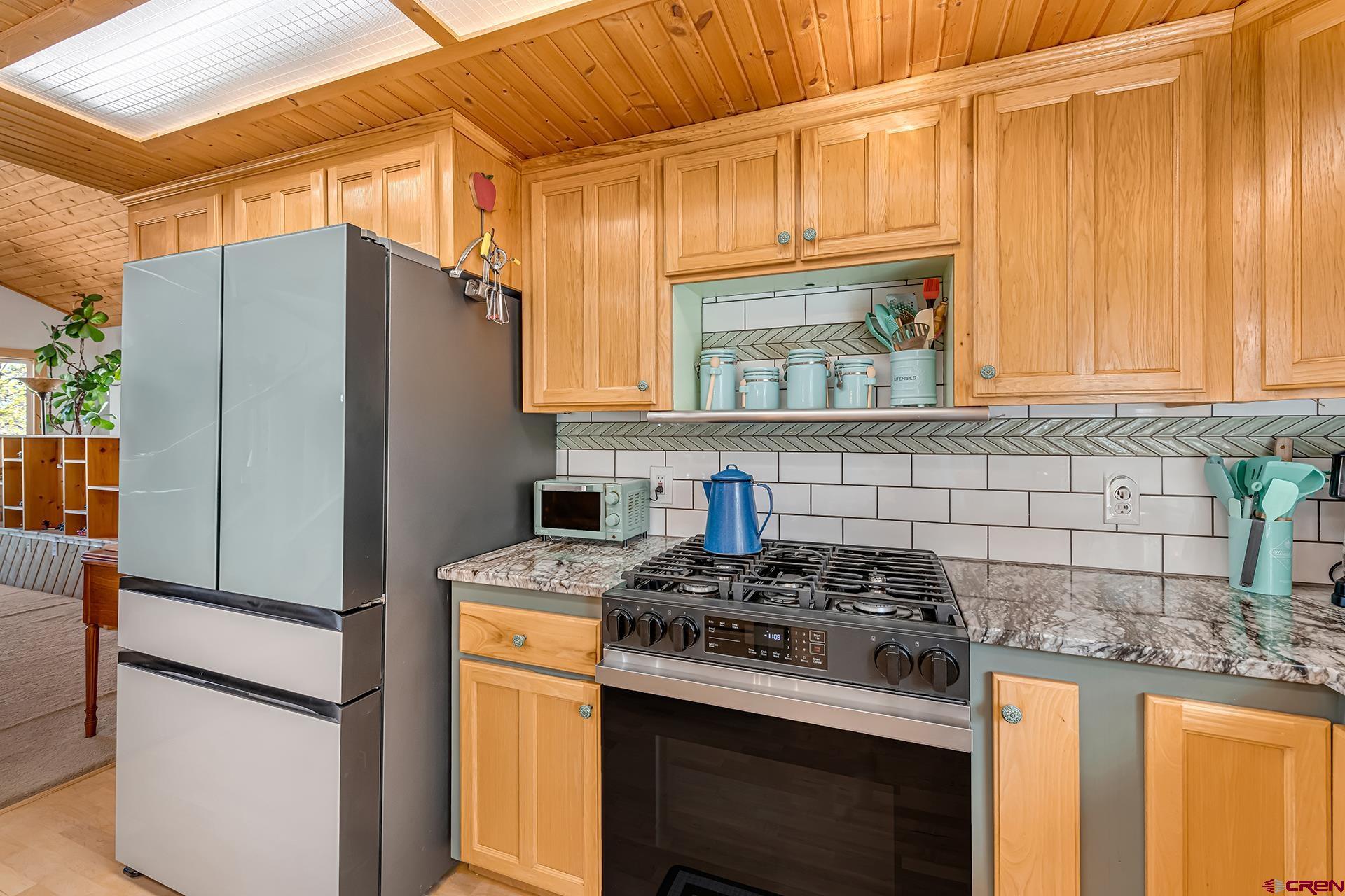 19122 2325th Road Cedaredge, CO 81413 - Photo 11 of 45 a kitchen with stainless steel appliances granite countertop a refrigerator stove and sink
