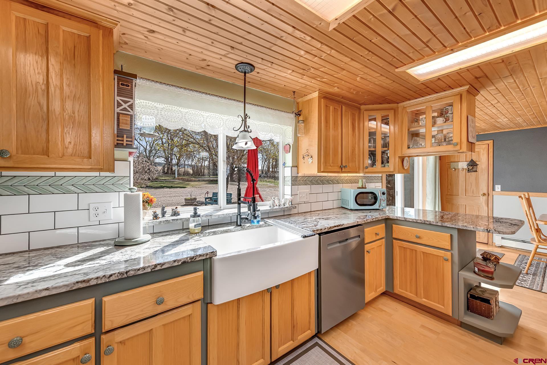 19122 2325th Road Cedaredge, CO 81413 - Photo 13 of 45 a kitchen with a sink stove and cabinets