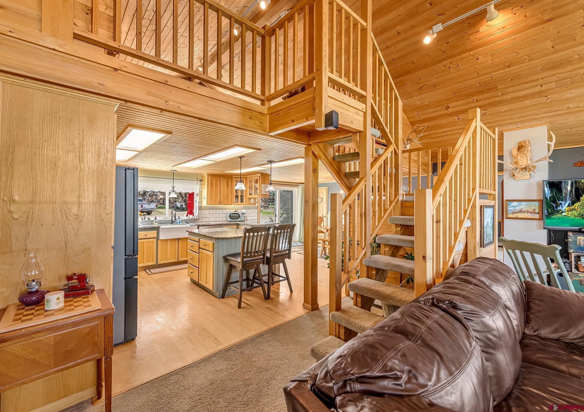 19122 2325th Road Cedaredge, CO 81413 - Photo 18 of 45 a living room with furniture a rug and white walls