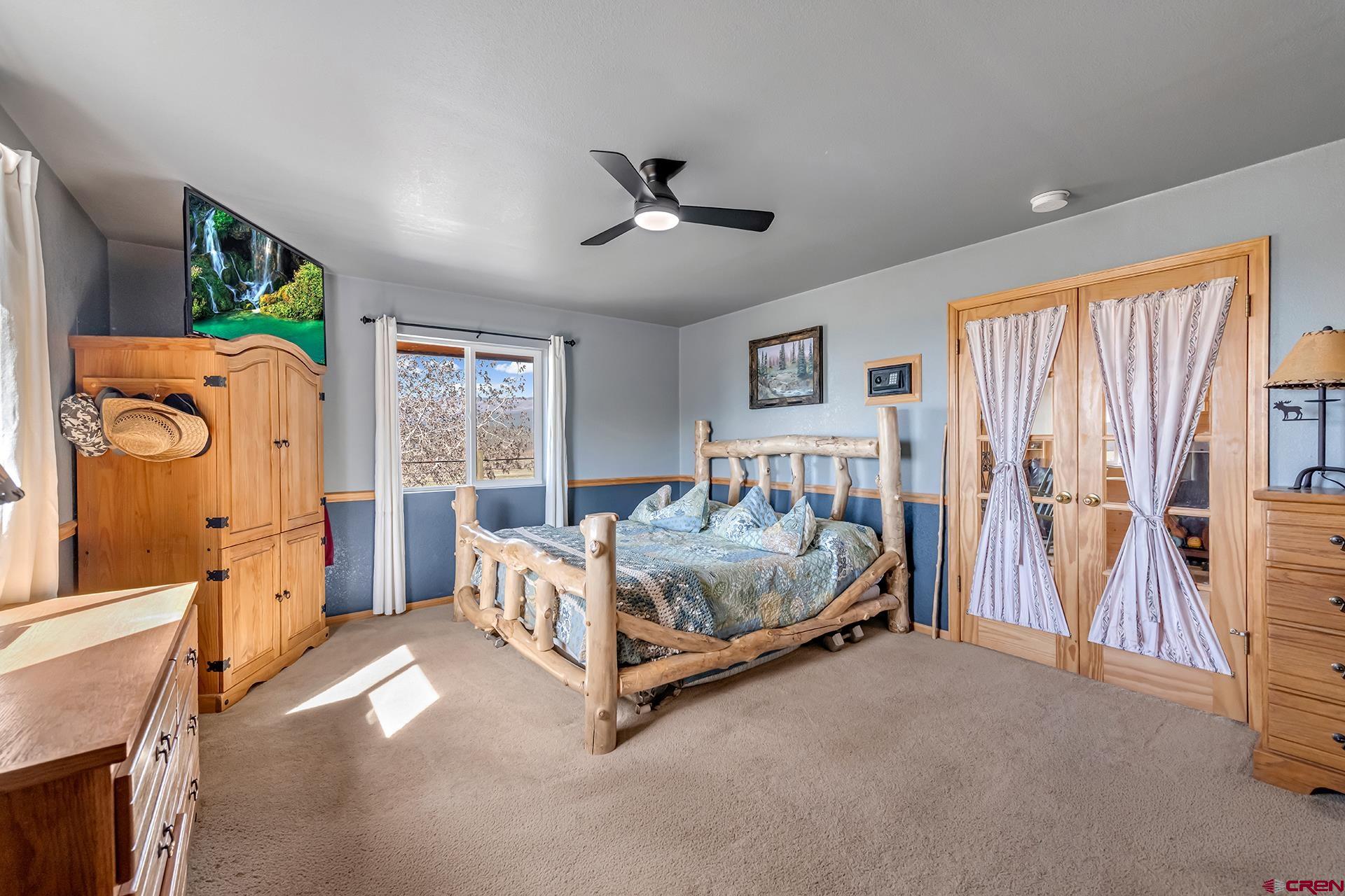 19122 2325th Road Cedaredge, CO 81413 - Photo 20 of 45 a bed room with a bed and a baby crib