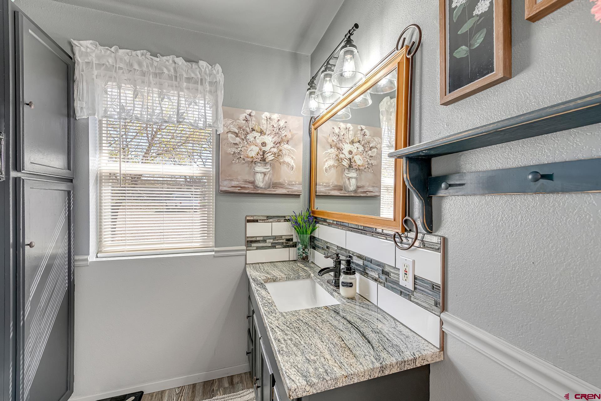 19122 2325th Road Cedaredge, CO 81413 - Photo 23 of 45 a dining room with furniture a rug and wooden floor