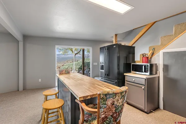 a kitchen with stainless steel appliances kitchen island granite countertop dining table chairs and granite counter tops