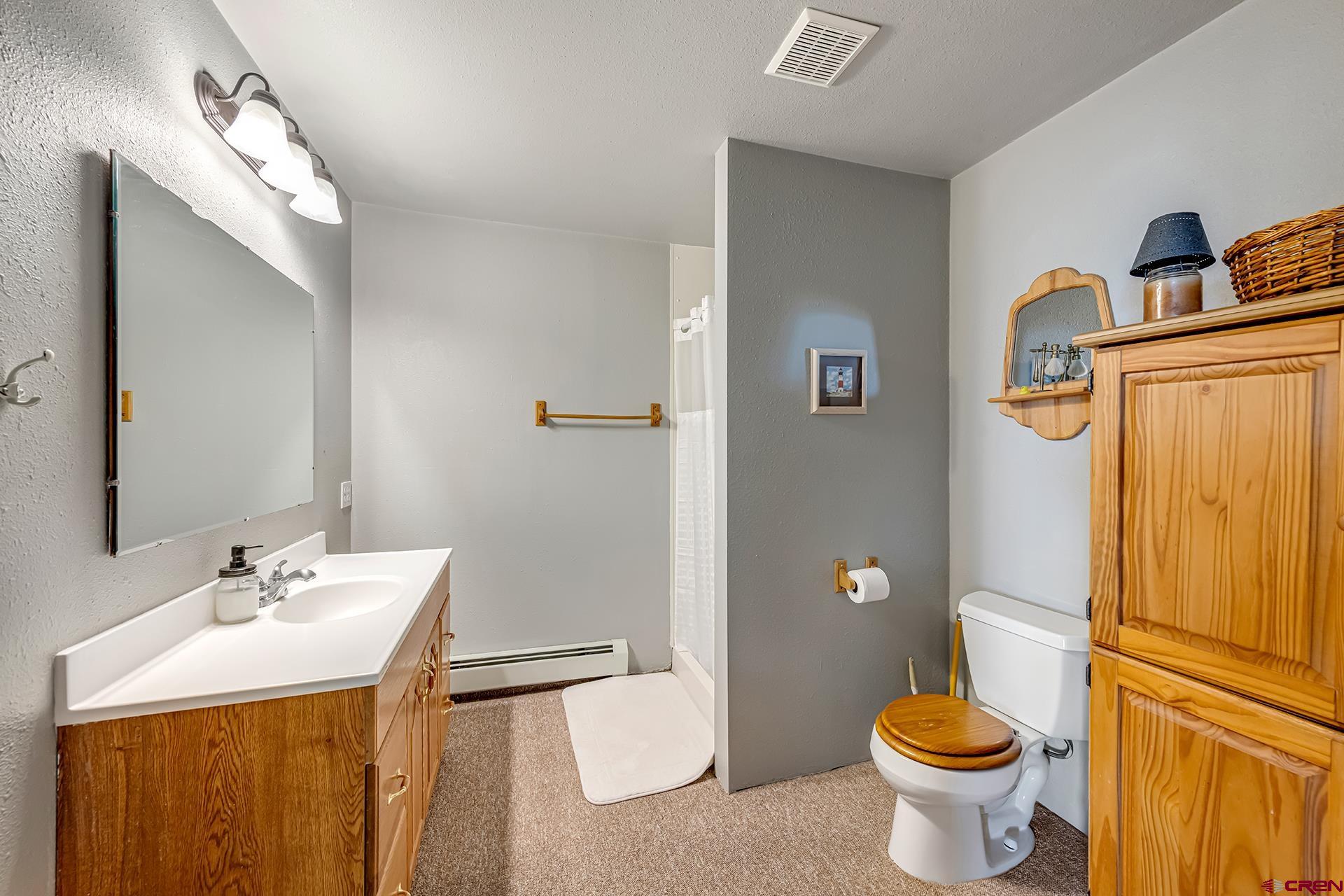 19122 2325th Road Cedaredge, CO 81413 - Photo 34 of 45 a bathroom with a sink toilet and shower