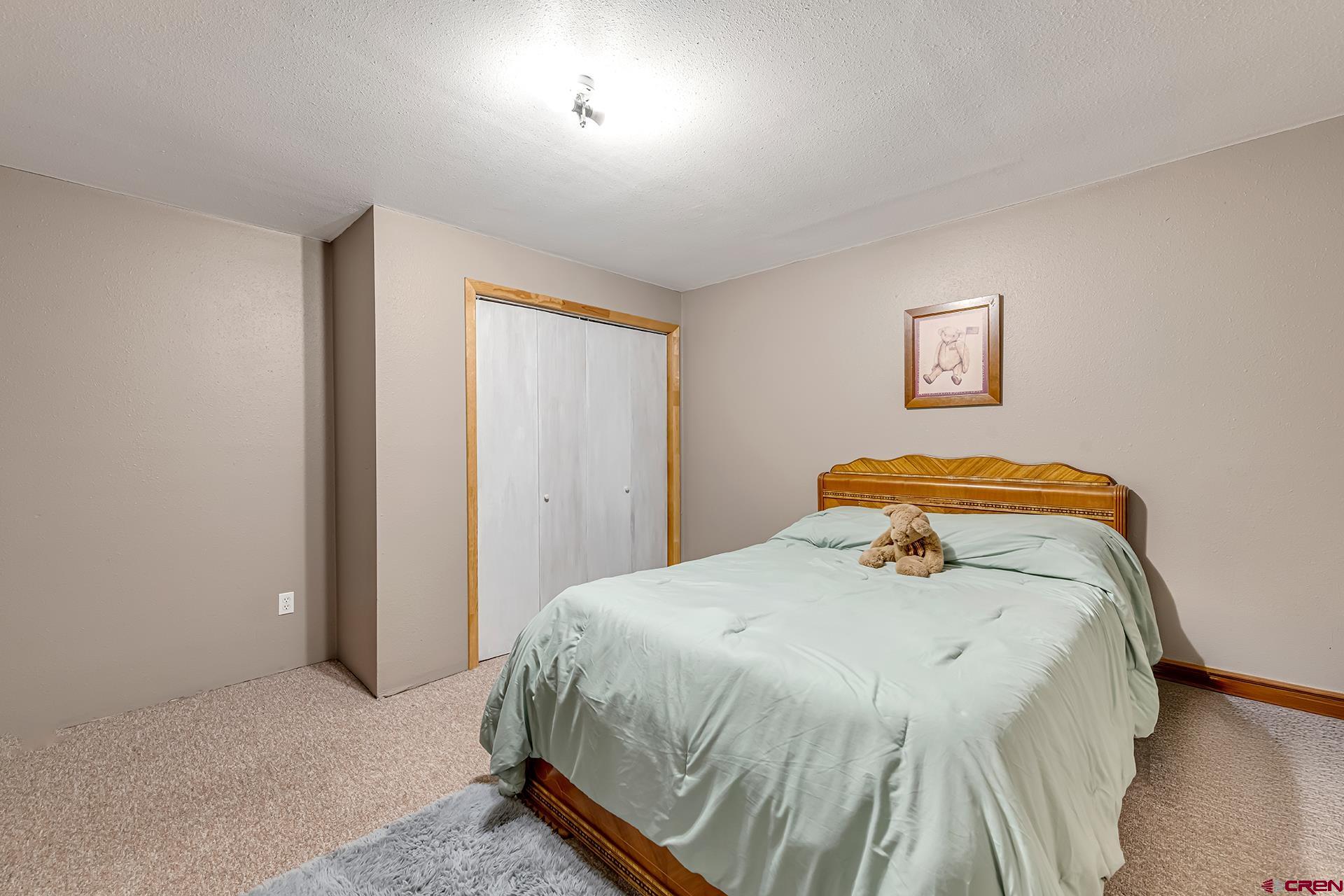 19122 2325th Road Cedaredge, CO 81413 - Photo 35 of 45 a bedroom with a bed and a window