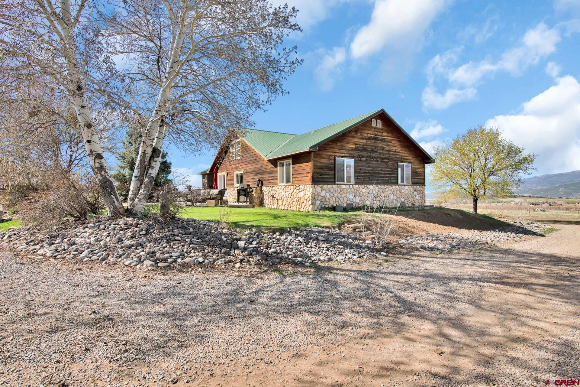 19122 2325th Road Cedaredge, CO 81413 - Photo 37 of 45 a front view of a house with a garden