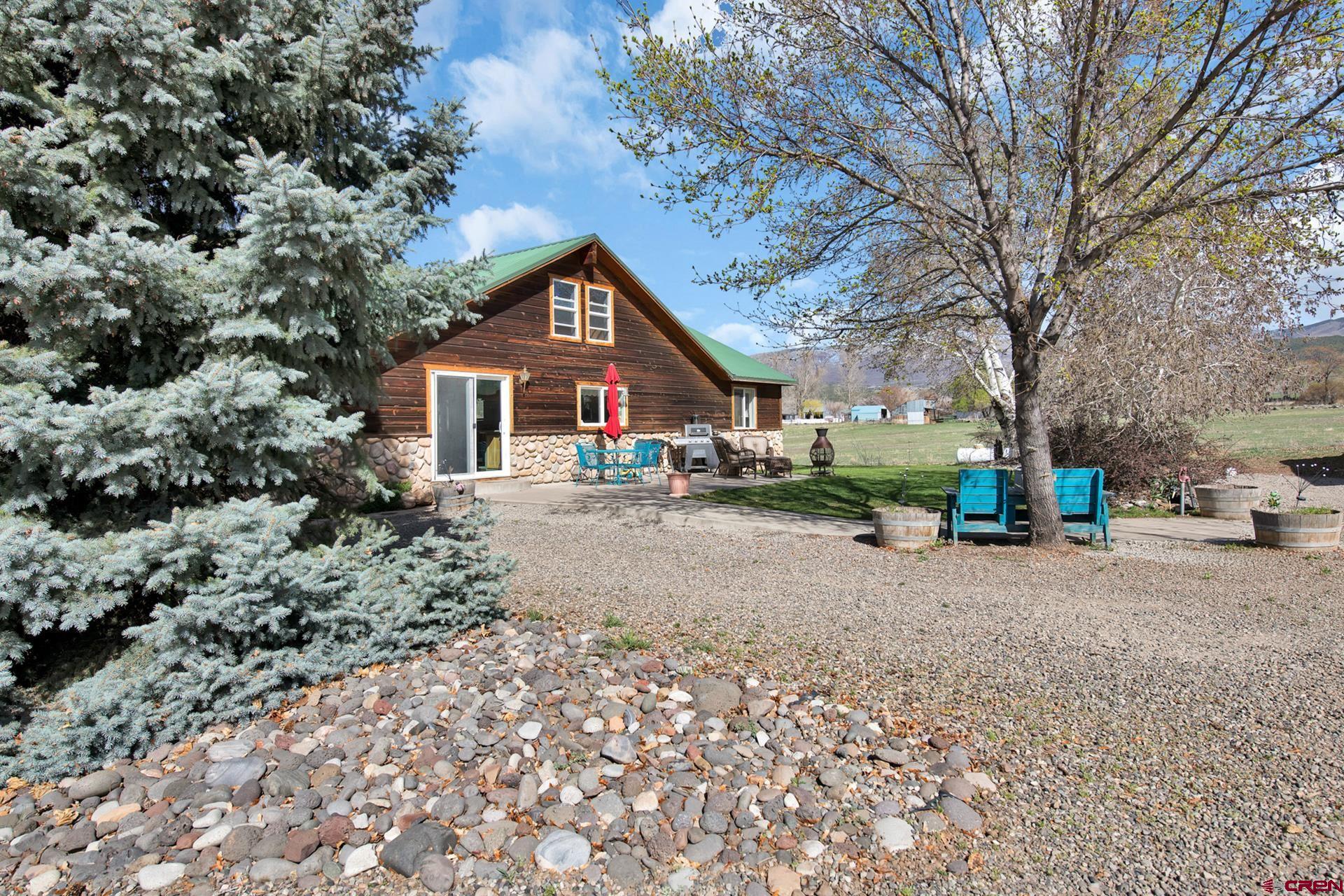 19122 2325th Road Cedaredge, CO 81413 - Photo 38 of 45 a front view of a house with a yard and trees