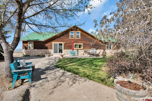 a view of a house with a yard and garage