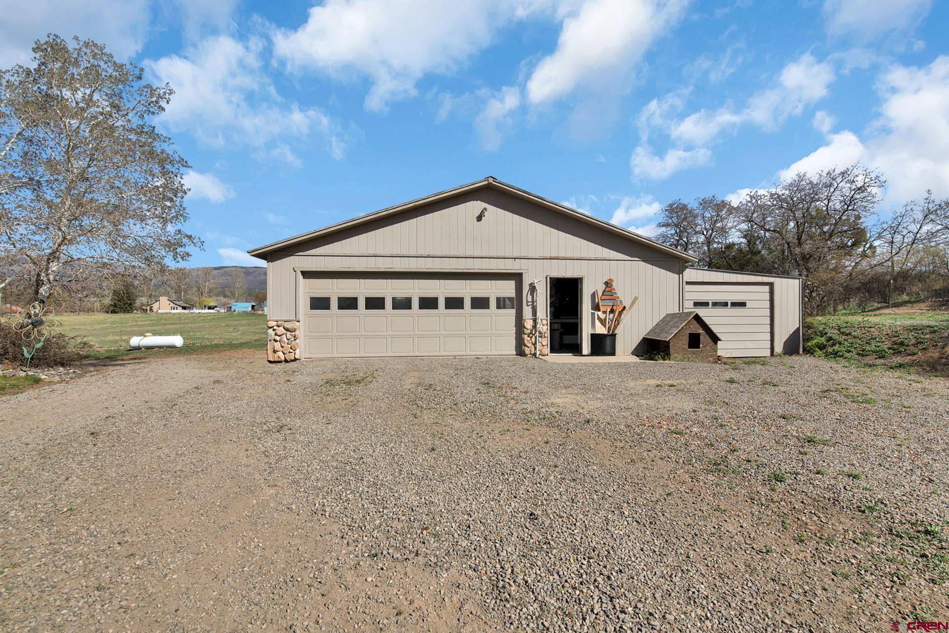 19122 2325th Road Cedaredge, CO 81413 - Photo 40 of 45 a view of a house with a yard and garage